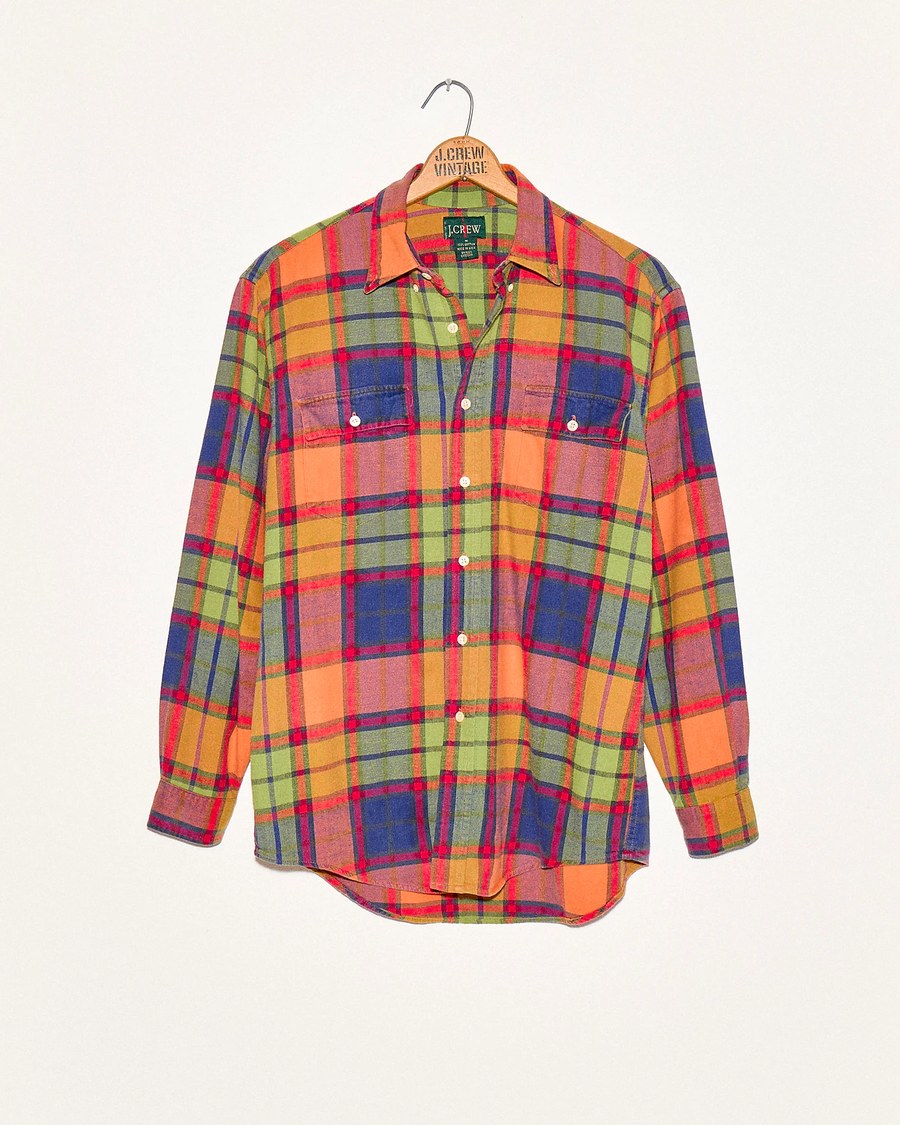 Bright plaid flannel shirt on a hanger