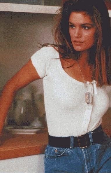 White knit top tucked into belted jeans
